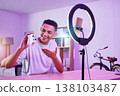Streamer, live streaming and man gamer with review of console controller on social media for connection on vlog. Ring light, influencer and content creator or person speaking on internet show as host 138103487