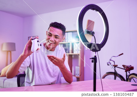 Streamer, live streaming and man gamer with review of console controller on social media for connection on vlog. Ring light, influencer and content creator or person speaking on internet show as host Streamer, live streaming and man gamer with review of console controller on social media for connection on vlog. Ring light, influencer and content creator or person speaking on internet show as host 138103487