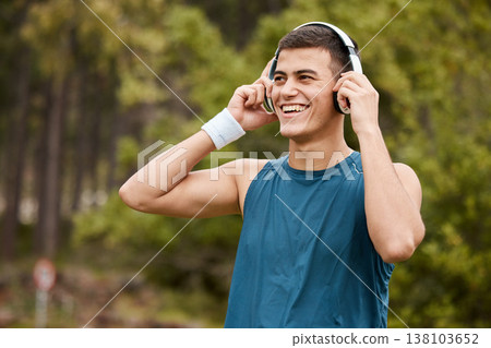 Fitness, headphones and a man outdoor listening to music or audio with wellness. Happy runner, athlete or sports person in nature park to start exercise, workout or training while streaming radio Fitness, headphones and a man outdoor listening to music or audio with wellness. Happy runner, athlete or sports person in nature park to start exercise, workout or training while streaming radio 138103652