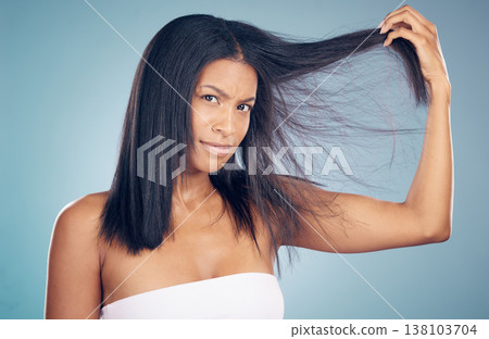 Hair loss, portrait or woman with split ends in studio or blue background for salon keratin treatment. Beauty, angry or frustrated model with messy hairstyle damage, bad texture or cosmetic problem 138103704