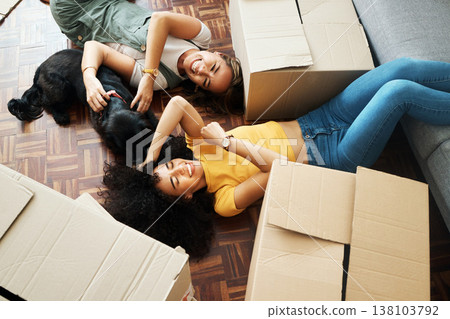 Moving, boxes and couple with a dog in new home, living room or women relax together on floor bonding with puppy or pet. Girls, laughing and happiness in house with people, love and animal from above Moving, boxes and couple with a dog in new home, living room or women relax together on floor bonding with puppy or pet. Girls, laughing and happiness in house with people, love and animal from above 138103792