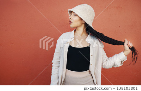 Fashion, hair and black woman in city with trendy outfit, cool clothes and style for glamour. Beauty, makeup and African person on orange wall background with confidence, pride and cosmetics in town 138103801