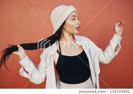 Fashion, hair and African woman in city with trendy outfit, cool clothes and style for glamour. Beauty, makeup and person on orange wall background with confidence, pride and cosmetics in urban town 138103802