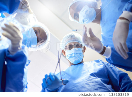 Hospital, tools and surgeon team in theatre for emergency, healthcare or medical procedure. POV, below and doctors for collaboration, portrait or surgery and operation with support and scrubs in ICU 138103819