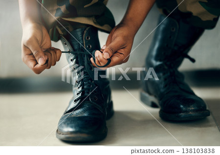 Hands tie shoes, closeup and soldier in army getting ready to start war, battle or fight. Boots, man tying laces in military and veteran preparing gear for training, exercise and workout to travel Hands tie shoes, closeup and soldier in army getting ready to start war, battle or fight. Boots, man tying laces in military and veteran preparing gear for training, exercise and workout to travel 138103838