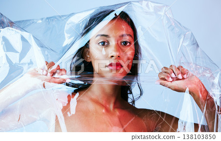 Plastic, woman and portrait with art, makeup and creativity in studio with cosmetics. Blue background, female person and packaging with unique aesthetic and skin glow with confidence and gloss 138103850