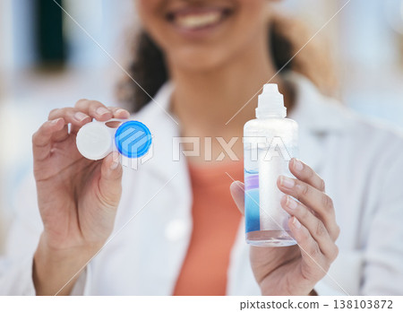 Optometry, contact lens and solution in hands, container and healthcare with eye care and wellness closeup. Person with bottle, vision and optometrist at clinic, case for lenses with advice and help Optometry, contact lens and solution in hands, container and healthcare with eye care and wellness closeup. Person with bottle, vision and optometrist at clinic, case for lenses with advice and help 138103872