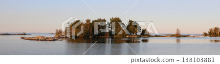 Small islands at sunset, calm water of Lake Vanern, Sweden. Small islands at sunset, calm water of Lake Vanern, Sweden. 138103881