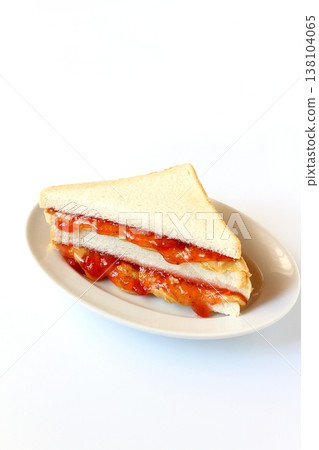 Peanut butter and jelly sandwich on a white background Peanut butter and jelly sandwich on a white background 138104065