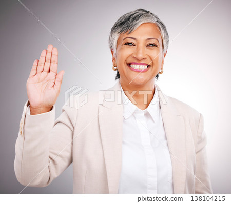 Portrait, senior woman and hand for loyalty, justice or a wave on a studio background. Happy, pledge and a mature employee or manager with a gesture for hello, pride or patriotic with respect Portrait, senior woman and hand for loyalty, justice or a wave on a studio background. Happy, pledge and a mature employee or manager with a gesture for hello, pride or patriotic with respect 138104215