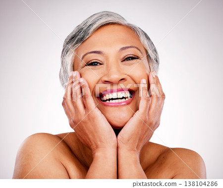 Happy senior woman, portrait and skincare in makeup or cosmetics against a studio background. Face of mature female person smile in happiness for healthy, perfect or soft skin from facial treatment Happy senior woman, portrait and skincare in makeup or cosmetics against a studio background. Face of mature female person smile in happiness for healthy, perfect or soft skin from facial treatment 138104286