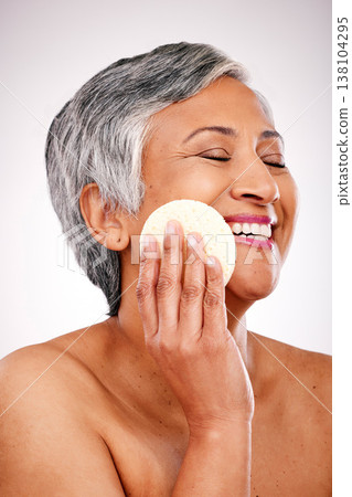 Face, mature happy woman and beauty sponge for anti aging wellness, morning self care and remove studio makeup. Bathroom grooming pad, eyes closed and relax person with clean skin on white background Face, mature happy woman and beauty sponge for anti aging wellness, morning self care and remove studio makeup. Bathroom grooming pad, eyes closed and relax person with clean skin on white background 138104295