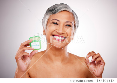 Senior woman, floss and studio portrait for transformation, beauty and healthy mouth by white background. Mature female model, teeth whitening and string for dental self care, cleaning and smile Senior woman, floss and studio portrait for transformation, beauty and healthy mouth by white background. Mature female model, teeth whitening and string for dental self care, cleaning and smile 138104312