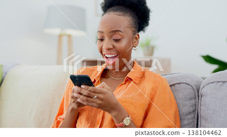 Excited, phone chat or black woman on couch in communication in house living room to relax. Smile, wow or happy African person texting or reading online gossip in a mobile app discussion on sofa Excited, phone chat or black woman on couch in communication in house living room to relax. Smile, wow or happy African person texting or reading online gossip in a mobile app discussion on sofa 138104462