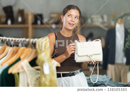 Woman choosing handbags in the store 138105383