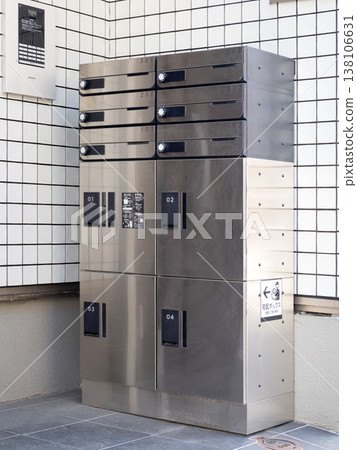 Apartment building with a shared mailbox with parcel delivery boxes. 138106631