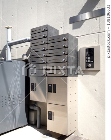 Apartment building with a shared mailbox with parcel delivery boxes. Apartment building with a shared mailbox with parcel delivery boxes. 138106633