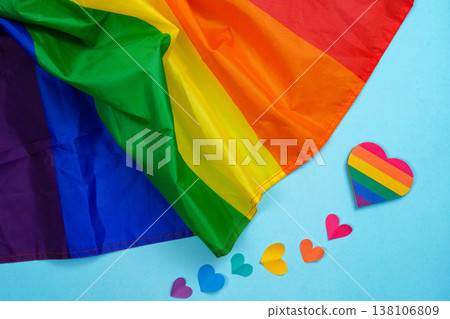 Rainbow flag and heart symbols on blue background 138106809