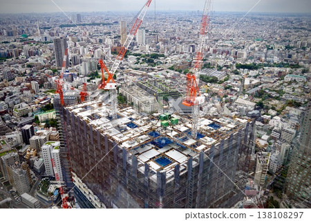 The forefront of urban development: Skyscrapers under construction and multiple large cranes. 138108297