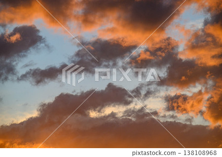 Dramatic sky at sunset, clouds glowing orange and deep blue Dramatic sky at sunset, clouds glowing orange and deep blue 138108968