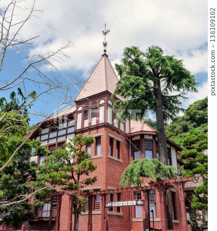 A historic building made of brick with a weather vane. A historic building made of brick with a weather vane. 138109102