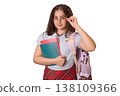 Confident Young Student with Glasses Holding Books and a Backpack, Ready for School Learning 138109366