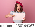 Surprised Child in a Red Beret Pointing at a Blank White Sign Against a Pink Background 138109367