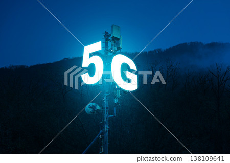 Bright 5G sign glowing at night near mountain area signaling fast internet service access 138109641