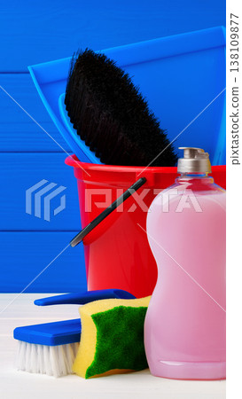 Cleaning tools and supplies arranged on a table with colorful background Cleaning tools and supplies arranged on a table with colorful background 138109877