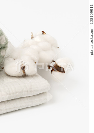 Cotton plants and soft fabric arranged for a simple display in natural light Cotton plants and soft fabric arranged for a simple display in natural light 138109911