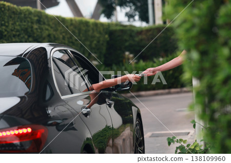 Hand Man in car receiving coffee in drive thru fast food restaurant.  138109960