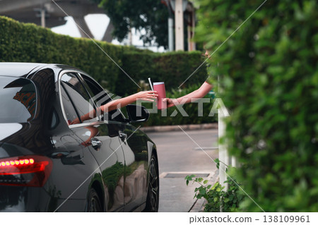 Hand Man in car receiving coffee in drive thru fast food restaurant.  138109961