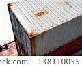 Stacked cargo containers with rust on shipping vessel deck 138110055