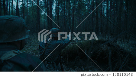 German soldier pointing direction in dark forest during WWII scout mission German soldier pointing direction in dark forest during WWII scout mission 138110148