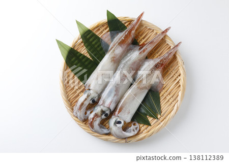 Squid served in a basket against a white background. Squid served in a basket against a white background. 138112389