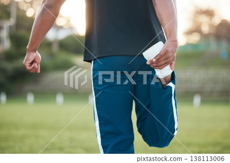 Person, fitness and stretching leg on grass getting ready for sports training, workout or outdoor exercise. Rear view of sporty athlete in warm up for preparation, motivation or health and wellness 138113006