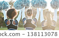 Back of cheerleader, sports and women on field for performance, dance and motivation for game. Teamwork, dancer and people in costume cheering for support in match, competition and event outdoors 138113078