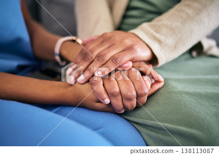 Hands, empathy and helping with life crisis, caregiver with patient for support and grief counseling. People sitting together, healthcare and wellness with advice, kindness and respect with trust 138113087