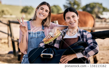 Horse, peace sign and portrait of women with saddle and brush for animal care, pet and happy on ranch. Farming friends, countryside and people with stallion for bonding, relax and adventure outdoors Horse, peace sign and portrait of women with saddle and brush for animal care, pet and happy on ranch. Farming friends, countryside and people with stallion for bonding, relax and adventure outdoors 138113162