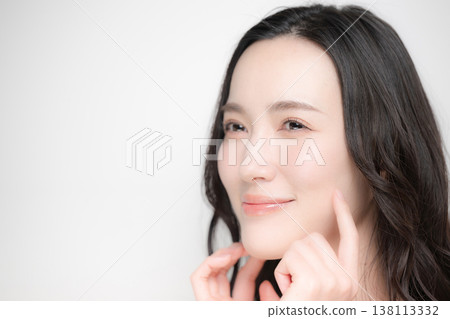 Moisturizing and hydrating the cheeks and cheeks, a beautiful close-up of skincare, esthetics, and beauty treatments. 138113332