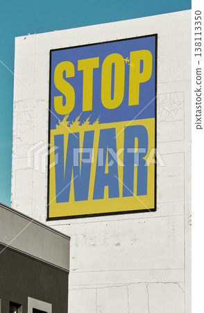 City, buildings and banner to stop war Ukraine, Russia and opinion for peace, support and solidarity. Poster, skyscraper and vote for kindness, love and no violence with freedom, justice or respect 138113350