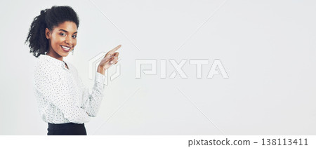 Pointing, mockup and portrait of happy businesswoman in studio with empty space for marketing or advertising. Banner, smile and professional person with show gesture for mock up by white background. Pointing, mockup and portrait of happy businesswoman in studio with empty space for marketing or advertising. Banner, smile and professional person with show gesture for mock up by white background. 138113411