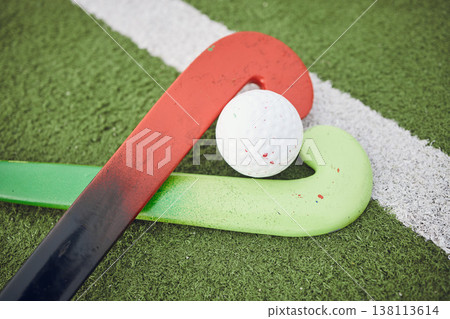 Hockey, stick and ball on green, field or pitch with sports equipment for game, competition or match on ground or floor. Artificial grass, heart or gear on turf for training in sport championship Hockey, stick and ball on green, field or pitch with sports equipment for game, competition or match on ground or floor. Artificial grass, heart or gear on turf for training in sport championship 138113614