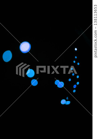 Bokeh, blue dots and dark wallpaper with pattern, texture and lights on mockup with cosmic aesthetic. Night lighting, sparkle particles and glow on dark wallpaper with space, color shine and flare. 138113653