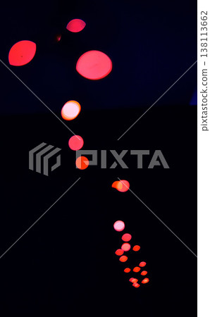 Bokeh, red lamp lights on black background with pattern, texture and dots mockup with cosmic aesthetic. Night lighting, sparkle particles and glow on dark wallpaper with space, color shine and flare. 138113662