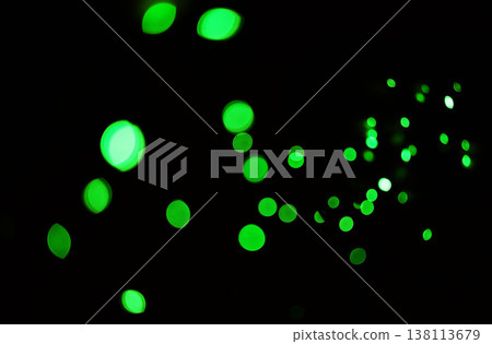 Green light, bokeh and glow on dark background isolated on a mockup space. Blur, black backdrop and defocused shine, sparkle or glitter at night for Christmas, holiday or party with magic color dots 138113679