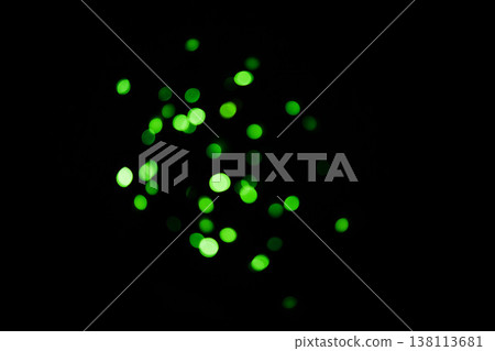 Green, lights and bokeh in a studio with dark background for celebration, event or party. Confetti, glitter and color sparkles for magic, shine or glow for festive by black backdrop with mockup. 138113681