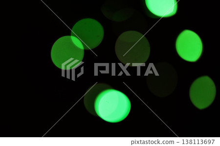 Green, bokeh and light in a studio with a dark background for celebration, event or party. Mockup, sparkle and color for glow, magic or shine for festive decoration by a black backdrop with mock up. 138113697