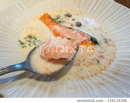 Clam chowder. A white stew containing clams and salmon fillets. Close-up. 138114306