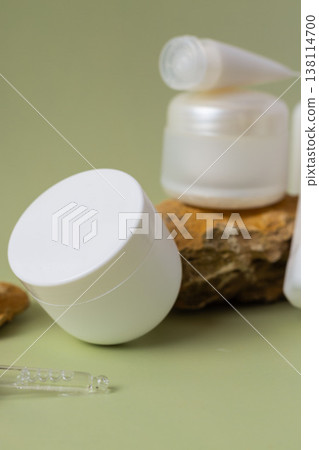 Flat lay of minimal skincare cosmetic bottles, tubes and cream jar on natural stones with soft green background Flat lay of minimal skincare cosmetic bottles, tubes and cream jar on natural stones with soft green background 138114700